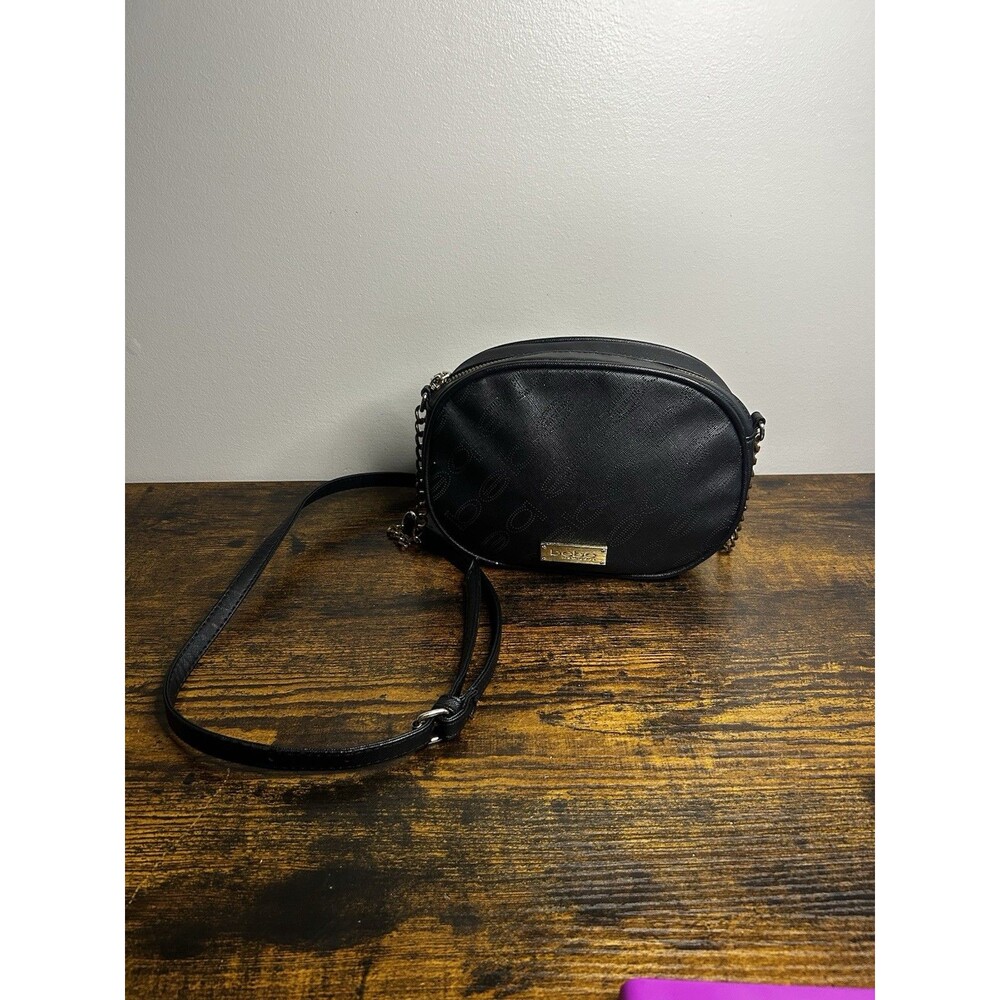 bebe crossbody bag with a gold-toned logo plaque and a curved silhouette